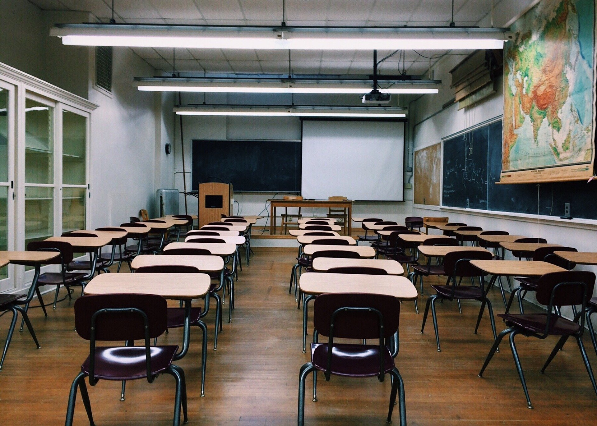 an empty classroom with blank chalkboards