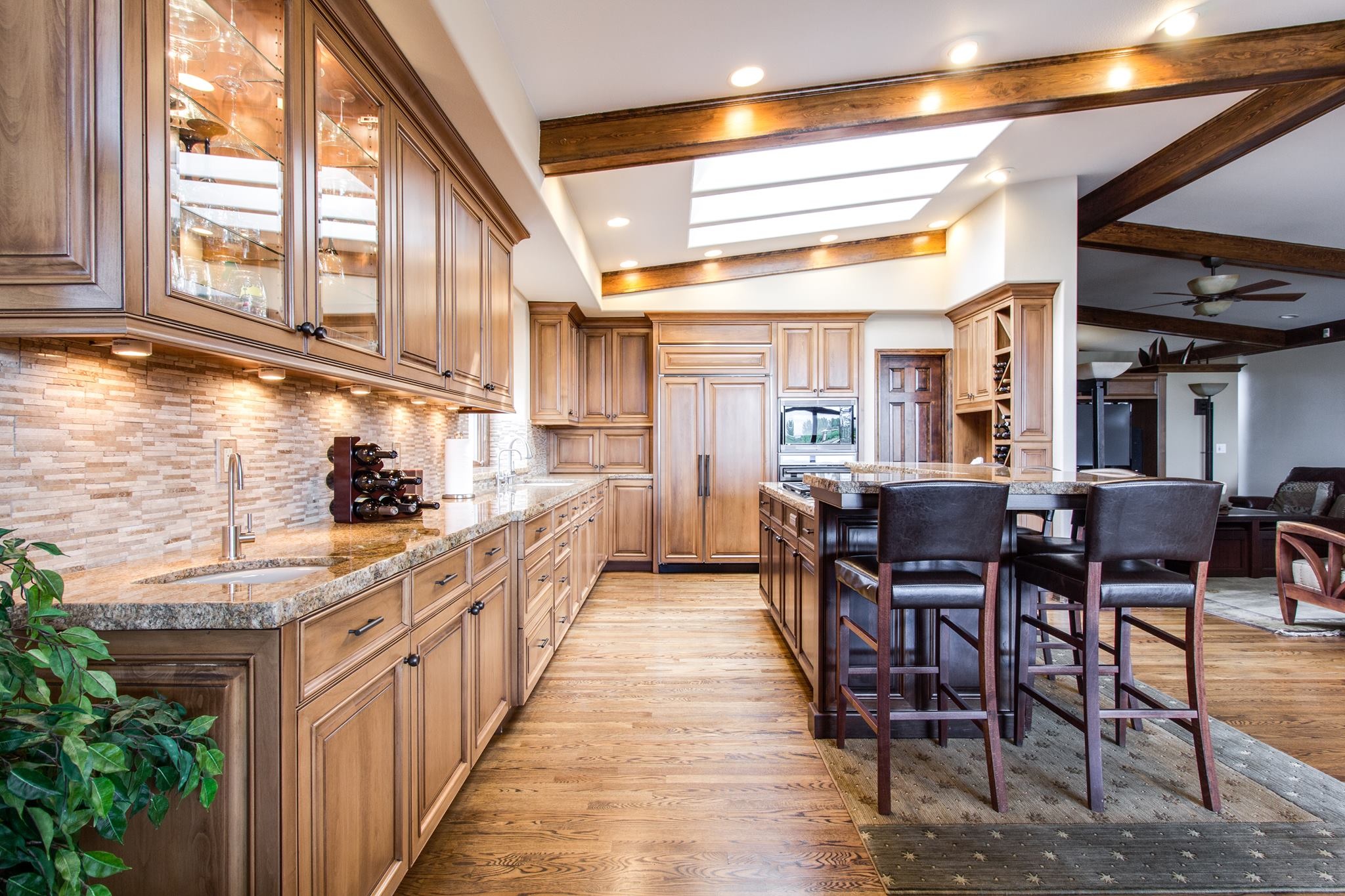 an open kitchen with a kitchen island with chairs and views of the living room