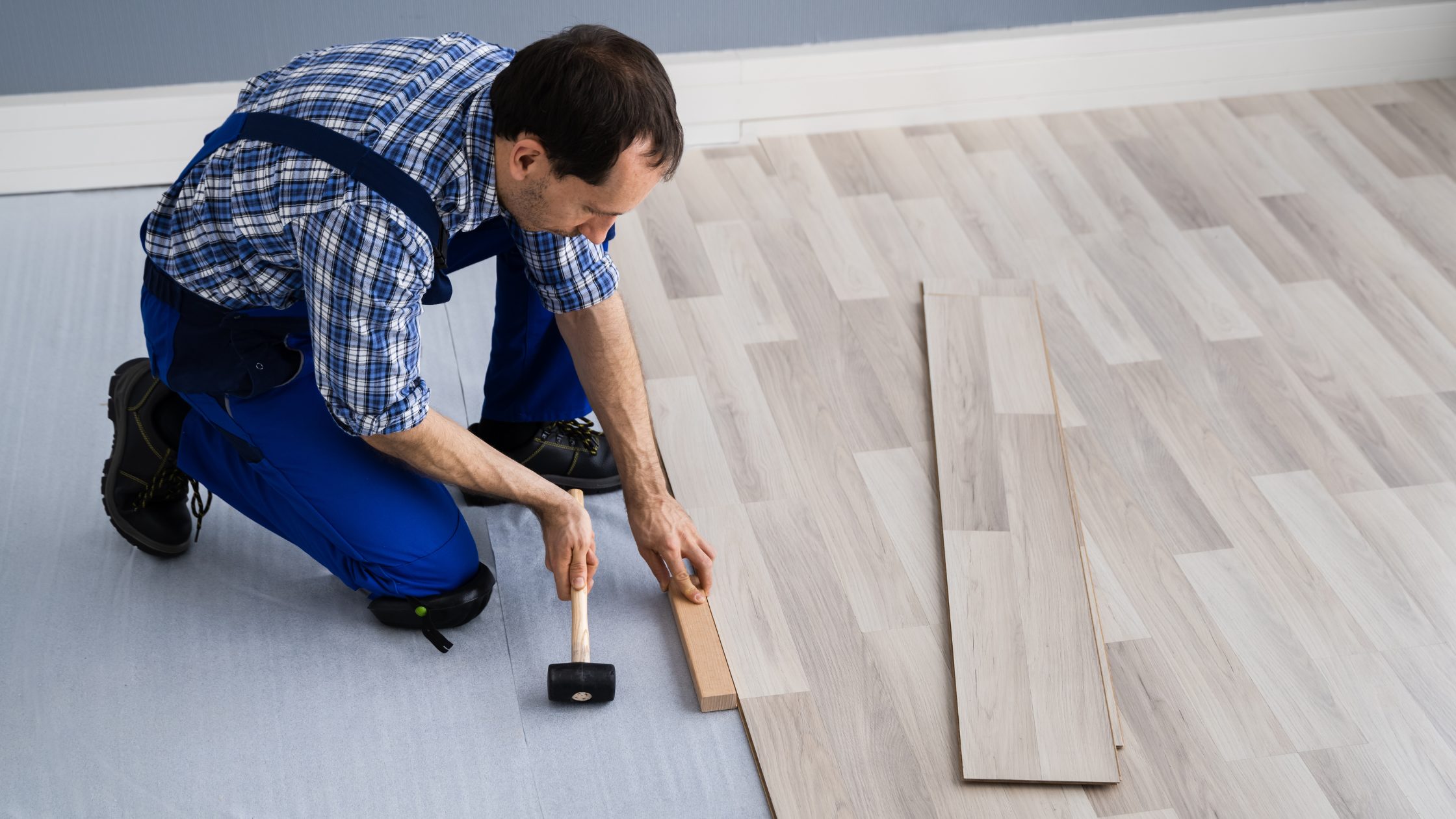 Man installing wood flooring